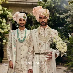 Here, two grooms stand together, each in a unique yet coordinated floral sherwani. I believe in creating ensembles that celebrate shared stories, ensuring both partners feel equally regal. This is a testament to love's legacy, detailed in soft hues and intricate threadwork.