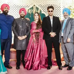 Capturing a moment with Punjabi music star Mankirt Aulakh and the happy couple's family.