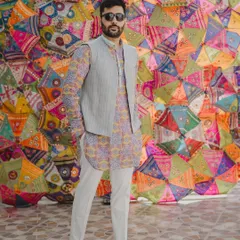 Adi Bhatia radiates color in this festive ensemble. I paired a vibrant printed kurta with a simple, structured grey bundi for a balanced and stylish Mehendi look.