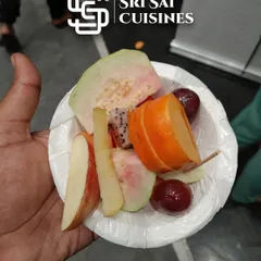 A fresh and healthy fruit bowl, featuring a mix of guava, apple, dragon fruit, persimmon, and grapes. It's a perfect light and nutritious option for any event.
