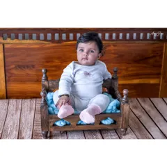 Here is Anika again, sitting confidently in a miniature wooden bed prop. At this age, babies are so interactive, which allows for these adorable and personality-filled portraits.