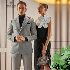 A campaign for John Cavendish featuring sophisticated power dressing. I styled the male model in a sharp grey double-breasted suit and the female model in a contrasting black dress with a bold floral accent to create a visually balanced and elegant composition.