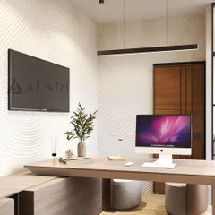 A close-up of the executive desk area, showcasing the clean lines of the furniture, integrated technology, and a sculptural wall texture illuminated by pendant lighting.