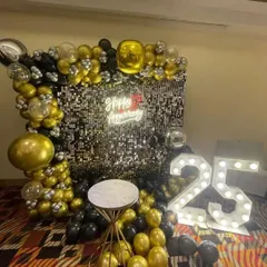 Another angle of the glamorous 25th-anniversary party setup, highlighting the metallic balloons and light-up numbers.