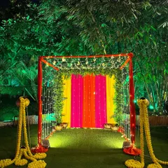 A vibrant and colorful entrance tunnel we created for a Diwali party, using bright fabric drapes and fairy lights to create a festive glow.