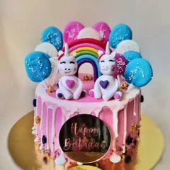 A double dose of magic for a twins' birthday! This adorable cake features two unicorns, a rainbow, and balloon toppers. It's as fun to make as it is to eat.