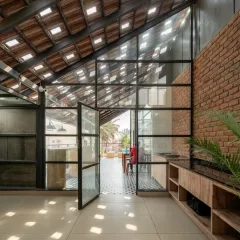 The redesigned terrace opens up to the outdoors, with large glass doors connecting the interior gym and cafeteria to the open-air seating area.