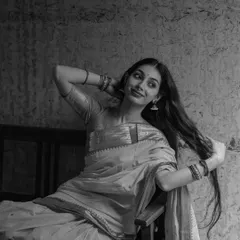 A black and white portrait exploring a moment of quiet femininity. The soft smile and pose are meant to feel gentle and introspective, showing a different, more subtle side of my expressive range.
