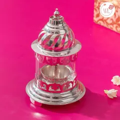 A beautifully crafted silver-plated lantern diya. This piece is a perfect example of a gift that is both functional for festive occasions and serves as a stunning decorative item in any home.