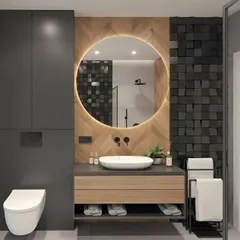 This modern bathroom design uses a bold, 3D black tile accent wall behind a backlit round mirror. The floating wood vanity and wall-mounted toilet keep the floor clear, making the space feel larger.