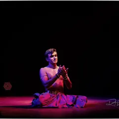 A moment of quiet contemplation during a solo recital. The performance is not just about movement, but also about finding stillness and emotion.
