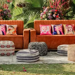 Comfort meets style in this outdoor Mehendi lounge. I used plush velvet sofas and a variety of quirky, printed cushions and poufs to create a relaxed and eclectic seating area for guests.