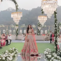 A breathtaking wide shot of the bride making her grand entrance on a mirrored aisle, flanked by guests and stunning floral decor at Athena, Powai.