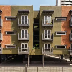 The facade of the Pixel 2 apartment building is a nod to Bengaluru's identity. We used locally sourced red bricks reminiscent of colonial architecture and a textured green plaster inspired by the "Garden City" tag. Each unit features a balcony with grills inspired by old bungalow gates, blending nostalgia with modern design.
