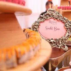 Our culinary offerings extend far beyond traditional Indian cuisine. This elegant live Sushi Bar, complete with an ornate sign, showcases our expertise in crafting authentic and sophisticated global food experiences for weddings.