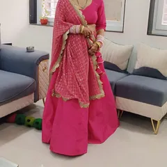 A happy client in her custom-made pink lehenga. We designed this simple yet elegant outfit with a plain silk skirt and a beautifully embroidered dupatta for a balanced and graceful look.