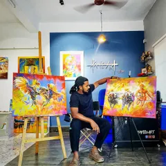 Here I am in my studio with two of my proudest creations celebrating Tulunadu culture. On the left is the 'Koroda Katta' and on the right is my 'Kambala' painting, both ready to find a new home.