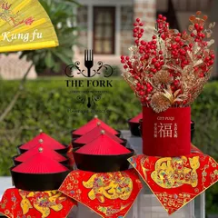 Thematic decor for our Chinese food station, featuring traditional red and gold elements. We believe in creating an immersive experience where the decor complements the cuisine.