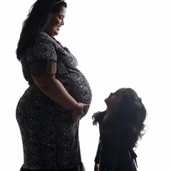 A silhouette is a timeless and artistic way to capture the bond between a mother and child. In the studio, we can play with light to create these dramatic, emotional portraits that focus purely on shape and connection.