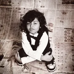 A unique high-angle shot that captures the confident and cool attitude of this young boy.