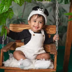 It's not Sunday, it's Panda Day! A happy baby in a panda hat enjoys a swing in our lush, bamboo-filled jungle setup.