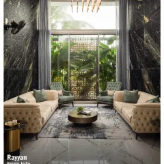 This double-height living room in the Rayyan project showcases how I blend luxury with comfort. The dramatic black marble walls and floor-to-ceiling windows create a space that is both grand and intimately connected to the lush greenery outside.