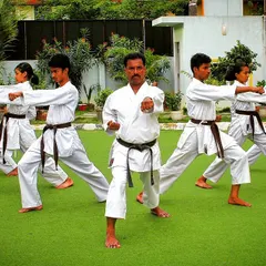 As a Renshi, I lead every class personally, ensuring each student masters the fundamental stances and punches. Here, we practice the zenkutsu-dachi stance, building a strong foundation together.