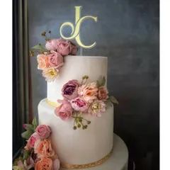 For timeless romance, I craft elegant wedding cakes like this three-tiered beauty. The clean white fondant serves as a perfect canvas for a cascade of handcrafted sugar flowers in soft, romantic hues, finished with a personalized monogram.