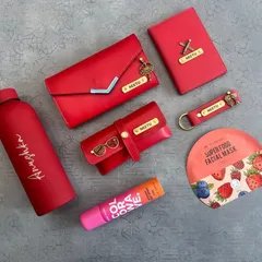 I love creating color-coordinated gift sets for her. This vibrant red collection features a personalized clutch, passport holder, keychain, and eyewear case, all with matching nameplates and charms. It's a complete, stylish set perfect for birthdays or anniversaries.