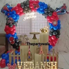 Another look at a popular Spiderman theme, this time with light-up letters spelling the birthday boy's name. The neon sign and detailed balloon work make it a fantastic backdrop for cake cutting.