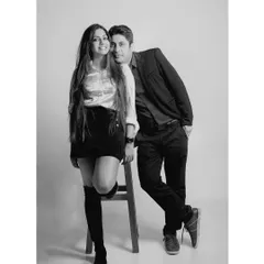 Another pose from the same studio session, this black and white photo has a timeless, elegant feel, focusing on their confident connection.