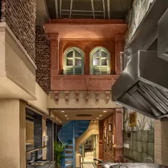 For the Shiv Mishthan Bhandar in Old Delhi, we created a double-height space featuring a traditional jharokha. This design blends heritage aesthetics with modern functional requirements, using craftsmen from Rajasthan to execute the details.