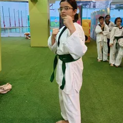 A student stands in her ready stance (Junbi). This photo captures the focus and determination we cultivate in all our martial artists.