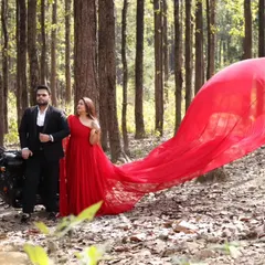 A bit of edge for your pre-wedding shoot. The classic red trail gown paired with a motorcycle in a forest setting shows just how versatile this piece is for telling your unique love story.