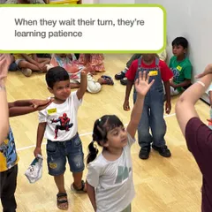 In the small moments, big lessons are learned. When children wait for their turn to raise their hands, they are not just participating in a game; they are learning patience and respect for others, all through simple, guided play.