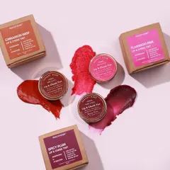 A beautiful flat lay of my three lip and cheek tint shades with their packaging. This image showcases the rich colors and natural aesthetic of the Cinnamon Wisp, Spicy Plum, and Flamingo Pink tints.