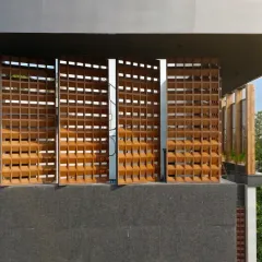 The façade of the House of Dancing Screens features these kinetic terracotta jaalis. More than just an aesthetic element, these screens pivot to control light and privacy, allowing the home to breathe and respond to the environment and the family's needs.