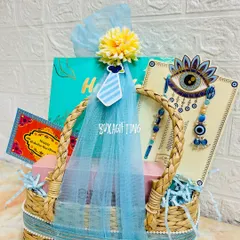 This premium Rakhi hamper for a brother and sister-in-law comes in a stylish grass basket with an evil eye rakhi set and other curated goodies.