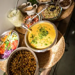 The beautiful and abundant spread at one of our holistic health retreats. We serve a variety of dishes like hearty soups, fresh salads, and chickpea preparations, all designed to nourish and heal from within.