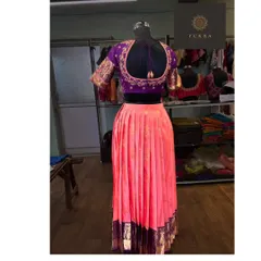 The back view of the purple and pink half-saree set, showing the deep U-back of the blouse and how it complements the overall outfit.