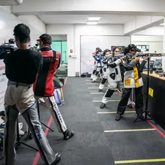 A full view of our 10m shooting range, where athletes train side-by-side, fostering a competitive and motivating atmosphere. The setup is professional, mirroring international competition standards.