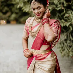 A candid moment of a bride in her stunning cream and pink Kanjeevaram saree, radiating happiness.