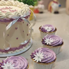 A detail shot showing the coordination between the main cake and the custom cupcakes. I love it when a full dessert table comes together like this.