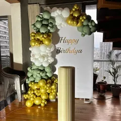 This simple backdrop with a balloon half-arch in olive green, gold, and white is perfect for smaller spaces. It provides a beautiful spot for photos without overwhelming the room.