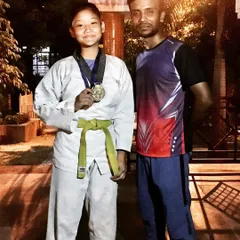 One of my dedicated students proudly displaying her medal. Her success is a direct result of her commitment during our rigorous training sessions.