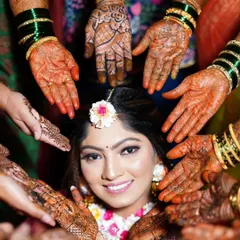 A beautiful shot from a Haldi ceremony, with the bride surrounded by loved ones, all showing off the mehandi we did for the entire bridal party.