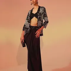 A full-length view of a modern ensemble from Ose Label. I styled this embroidered jacket with draped trousers to create a sophisticated fusion look that is perfect for cocktails or festive events, highlighting the brand's unique design language.