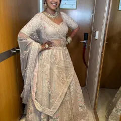 The bride strikes a happy pose, showing off her beautiful lehenga. The makeup is light and fresh, allowing her to feel comfortable and be herself.
