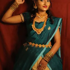 Here you can see the full traditional attire, where the makeup complements the beautiful teal saree and temple jewelry. I guide my students on how to create a balanced look that considers the entire outfit and occasion.