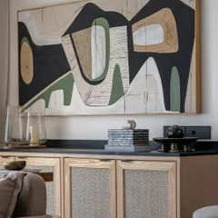 This large-scale abstract canvas was designed for a modern living space in Mumbai. The composition uses earthy tones, black, and white to create a sophisticated and balanced look that enhances the room's decor.